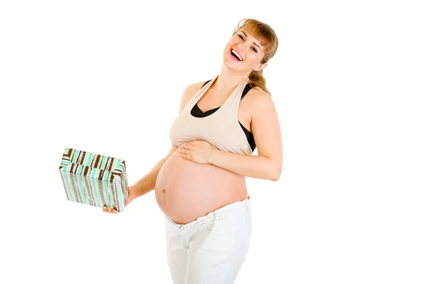 Laughing pregnant woman holding gift for her baby — Stock Photo, Image