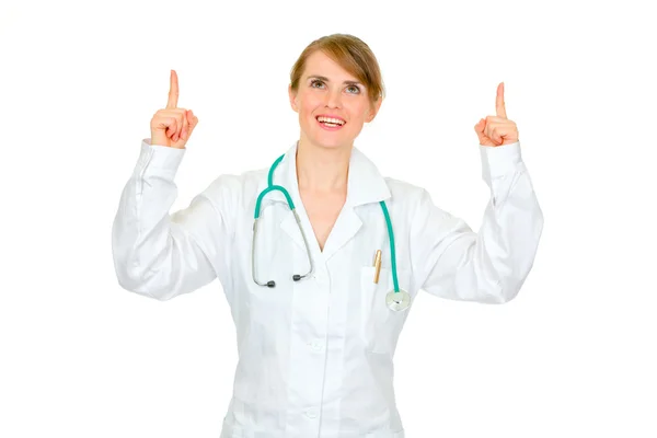 Médica sorridente apontando para cima — Fotografia de Stock