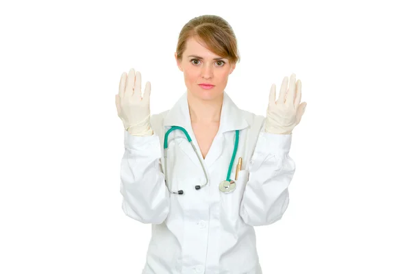 Concentrated doctor woman holding up hands in latex medical gloves — Stock Photo, Image