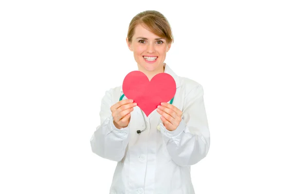 Smiling medical female doctor holding paper heart in hands — Stock Photo, Image