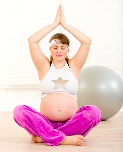 Piękna kobieta w ciąży robi joga na piętrze w domu — Zdjęcie stockowe