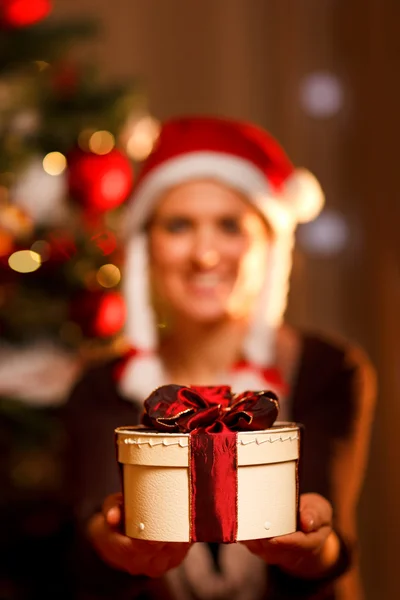 Closeup on hand presenting gift box and smiling woman and Christ Stock Image