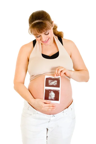 Happy pregnant woman holding echo near her belly — Stock Photo, Image