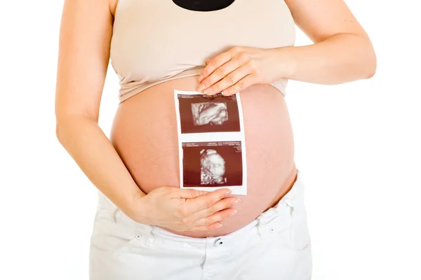 Pregnant female holding echo in hands. Close-up. — Stock Photo, Image