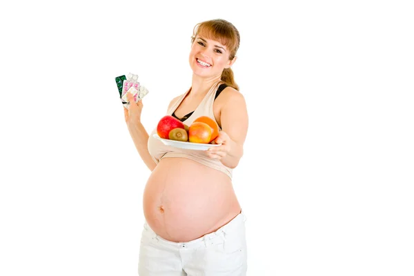 Leende gravid kvinna att välja hälsosam livsstil Royaltyfria Stockbilder