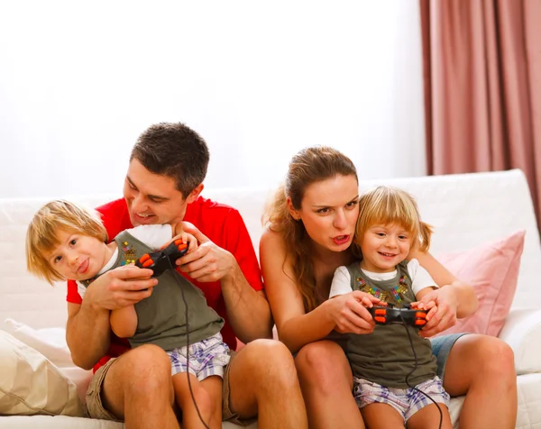Family spending time together and playing on console at home — Stock Photo, Image