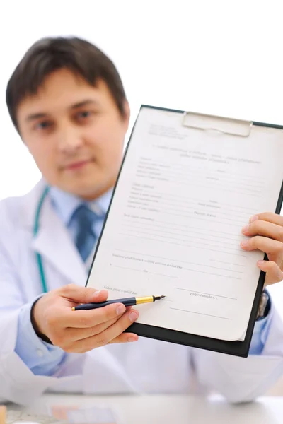 Medical doctor giving clipboard for you to sign — Stock Photo, Image