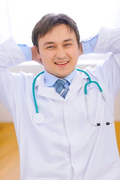 Happy medical doctor relaxing on chair at office — Stock Photo, Image