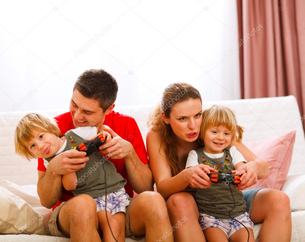 Family spending time together and playing on console at home