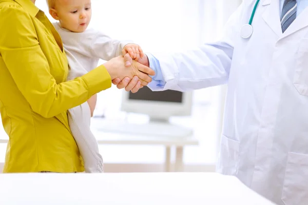 Closeup on doctor's mother's and baby's hands in handshake — Stock Photo, Image