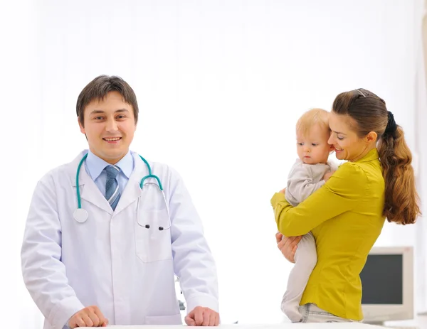Portrait of pediatric doctor and mother with baby on examination Royalty Free Stock Photos