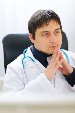 Portrait of thoughtful medical doctor clipart