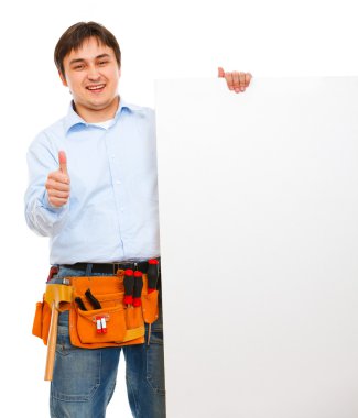 Construction worker holding blank billboard and showing thumbs u clipart