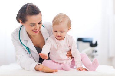 Cheerful baby high five to pediatrician doctor clipart