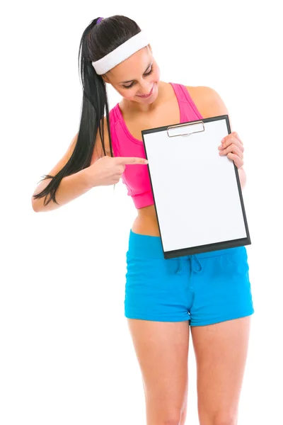 Slim girl pointing on blank clipboard — Stock Photo, Image