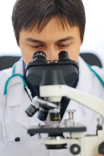 Primer plano del médico que mira en el microscopio — Foto de Stock