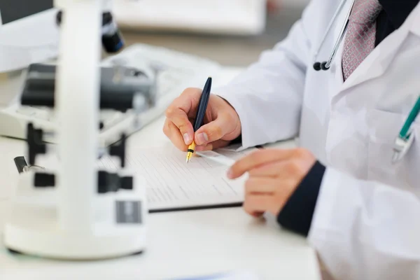 Closeup on hands of medical doctor working with documents — Stock Photo, Image