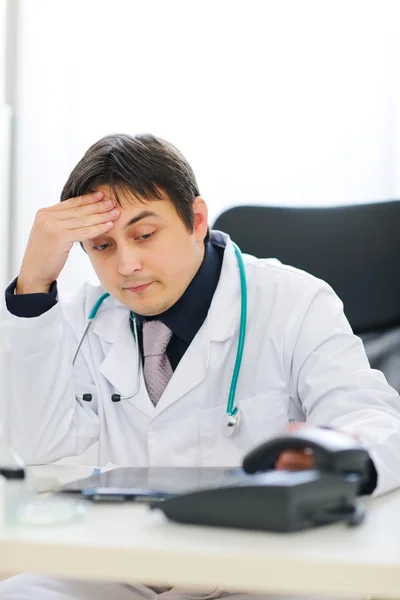 Concerned medical doctor picking up phone — Stock Photo, Image