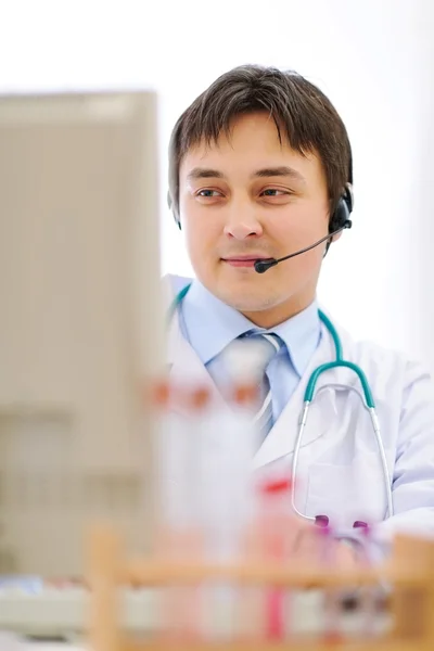 Medical doctor with headset working on computer — Stock Photo, Image