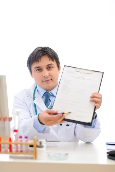 Medical doctor stretching clipboard for you to sign — Stock Photo, Image