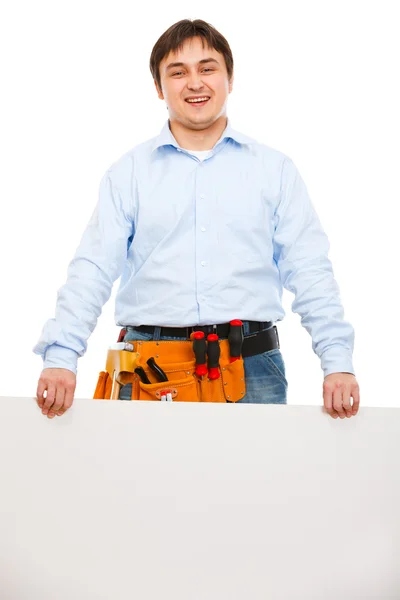 Construction worker holding blank billboard — Stock Photo, Image