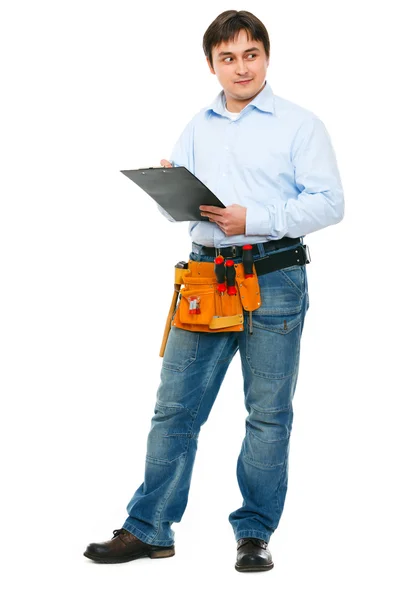Construction worker with clipboard looking on side — Stock Photo, Image