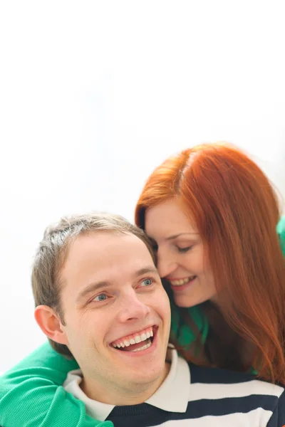Red hair young woman whispering in boyfriends ear — Stock Photo, Image