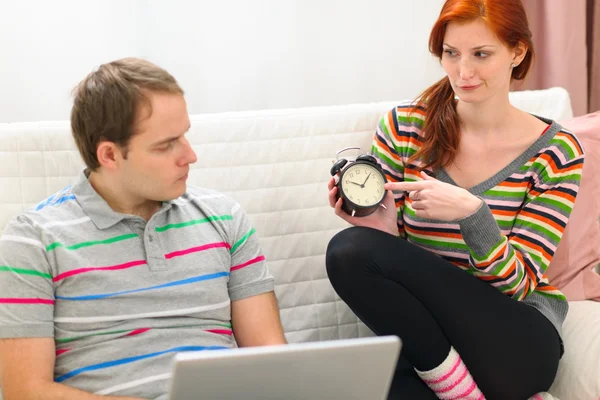 Red hair young woman hinting to boyfriend it's time to spend tim — Stock Photo, Image