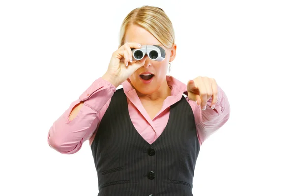 Surprised woman employee looking through binoculars and pointing — Stock Photo, Image