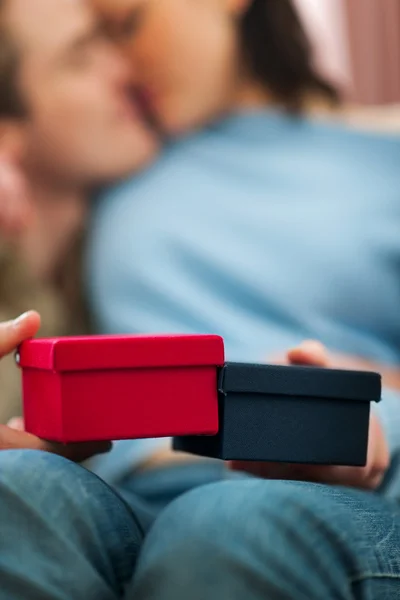 Closeup on present boxes holding by romantic couple — Stock Photo, Image