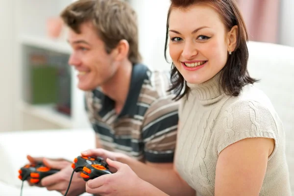 Young couple plying on console — Stock Photo, Image