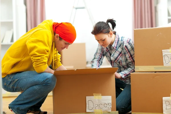 Young couple unpacking in new house — Stock Photo, Image