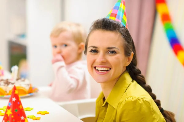 Portrait de mère et bébé manger gâteau d'anniversaire en arrière-plan — Photo