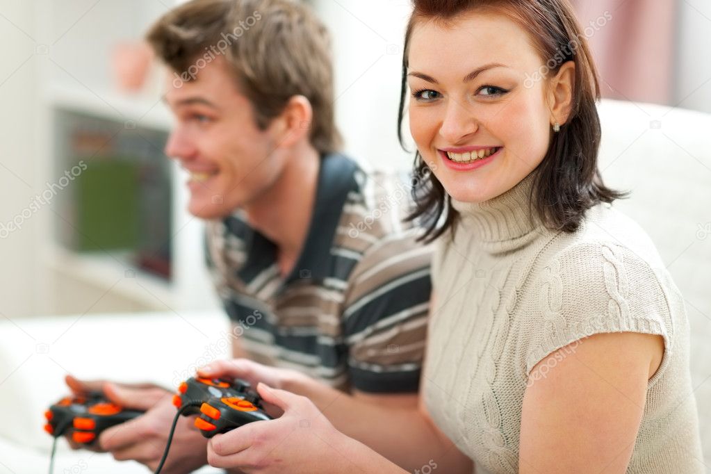 Young couple plying on console