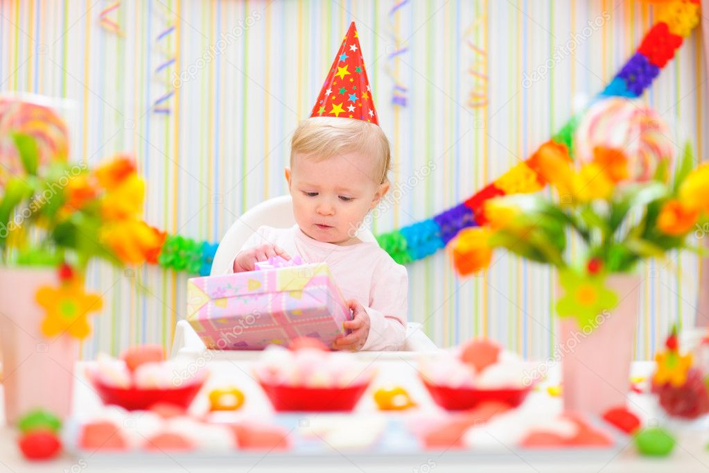 Surprised baby looking on present on first birthday — Stock Photo ...