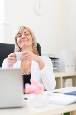 Senior business woman having cup of coffee and dreaming about va clipart