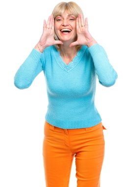 Happy senior woman shouting through megaphone shaped hands clipart