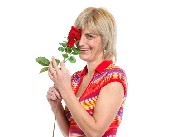 Happy middle age woman enjoying red rose — Stock Photo, Image