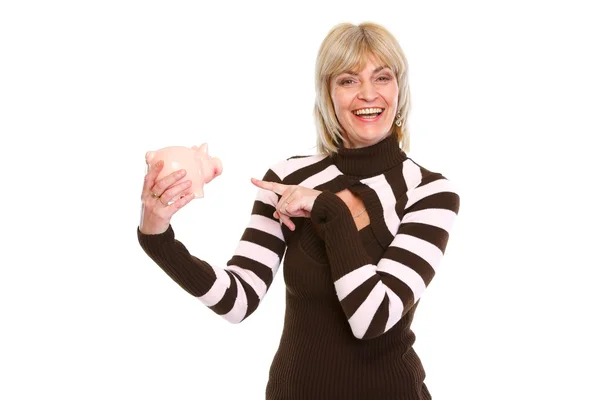 Glad äldre kvinna som pekar på spargris — Stockfoto