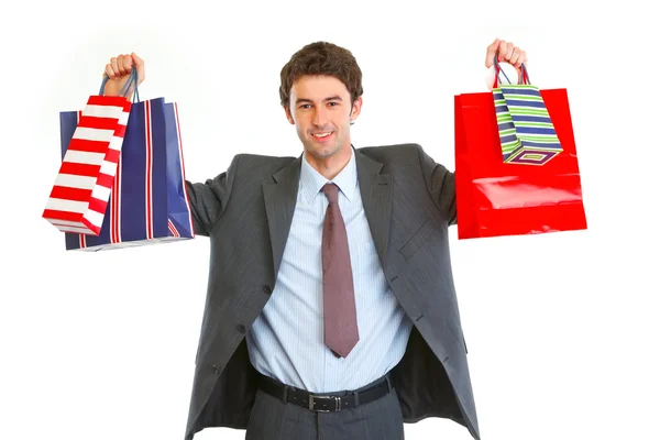 Szczęśliwy człowiek w garniturze z torby na zakupy w ręce — Zdjęcie stockowe