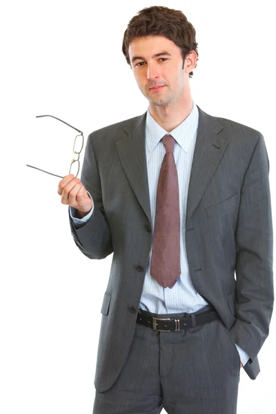 Thoughtful businessman holding eyeglasses — Stock Photo, Image