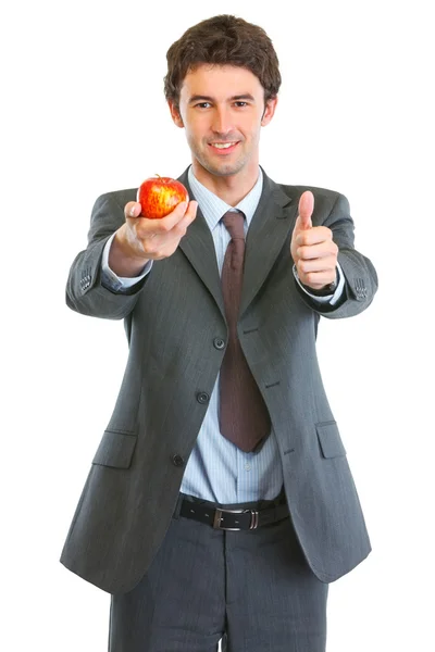 stock image Modern business man showing apple and thumbs up