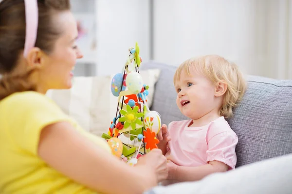 Moeder en baby spelen met Pasen decoratie — Stockfoto