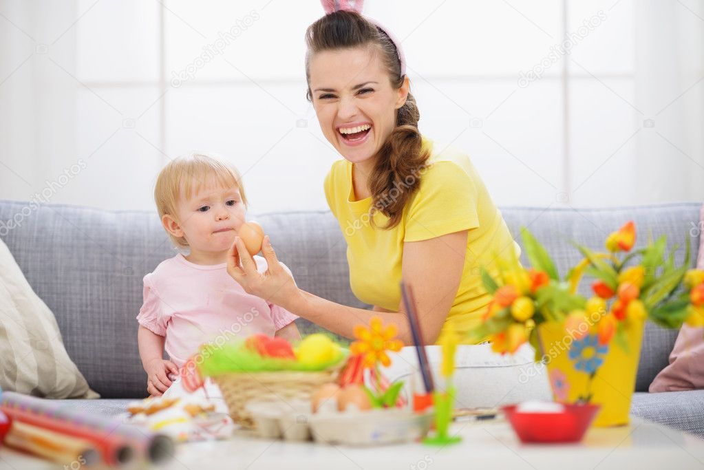 Mother giving baby Easter egg