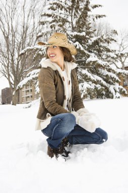 Woman with snowball. clipart