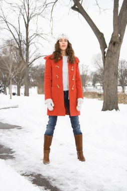 Woman in snowy street. clipart