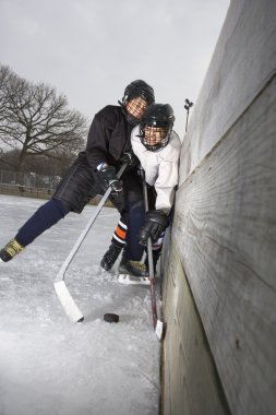 Boys playing ice hockey. clipart