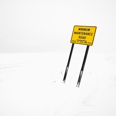 Road sign in blizzard. clipart