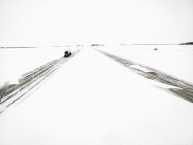 Highway in a winter storm. clipart