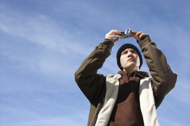Teen taking picture. clipart
